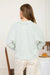 Women’s long sleeve knit polo with textured fabric and modern exposed seam accents