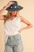 Casual women’s tank top paired with jeans for relaxed boutique style