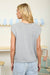 Round neck sleeveless cardigan styled with tank top