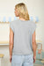 Round neck sleeveless cardigan styled with tank top