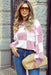 Women’s pink geometric checkered bishop sleeve sweater front view