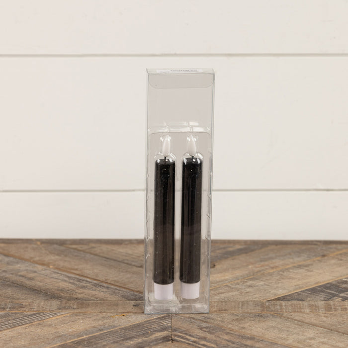 Close-up of black flameless taper candle showing realistic flame effect and elegant design
