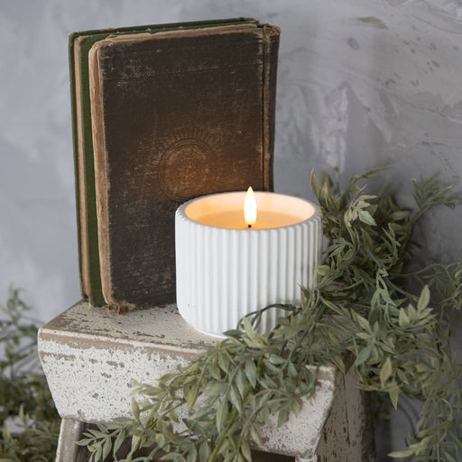 White ribbed ceramic flameless candle styled with home décor at Heartland Store MN
