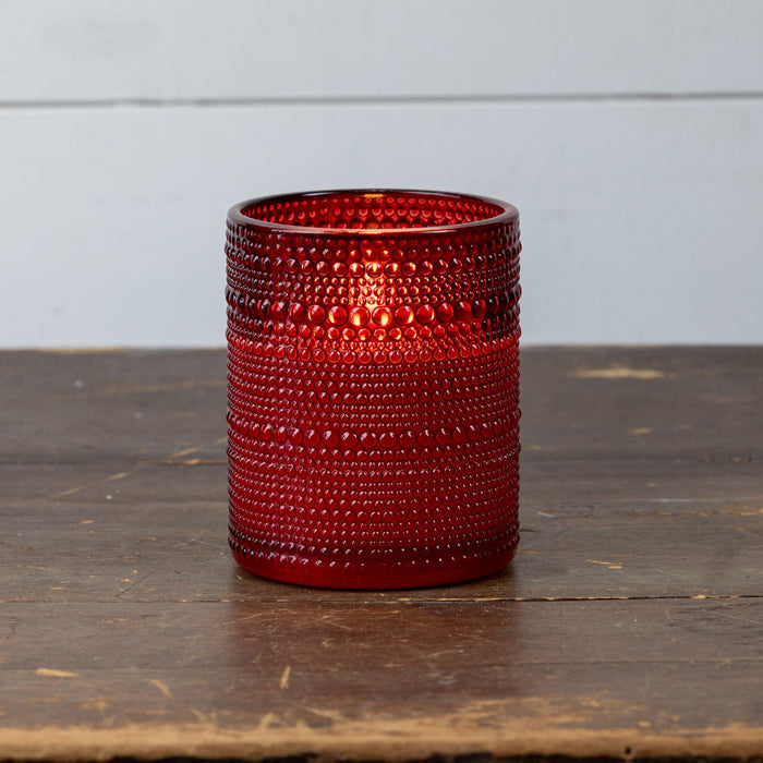 Close-up view of red dotted glass texture on battery-operated flameless LED candle