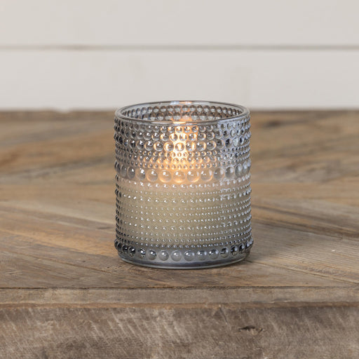 Grey glass flameless candle with timer displayed in home decor setting