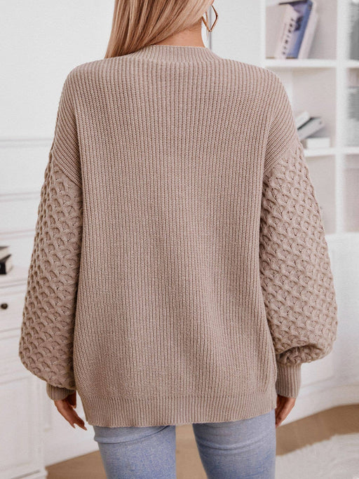 Back detail of classic two-tone women’s cardigan sweater in neutral colors