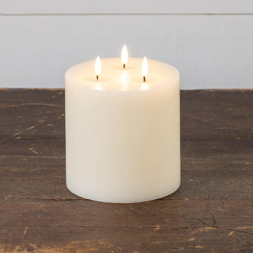 Battery-operated LED candle with three wicks and built-in timer