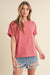 Woman wearing Mali Baby Tee short sleeve fitted top styled with casual denim shorts