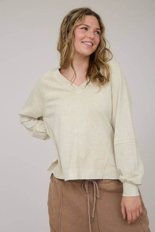 Women’s knit pullover with exposed seams and long sleeves