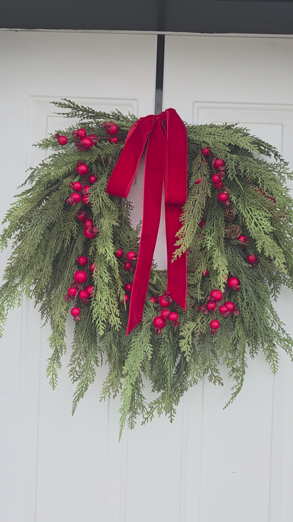 Artificial 28-inch cedar pine wreath with red berries and velvet ribbon – Heartland Store MN