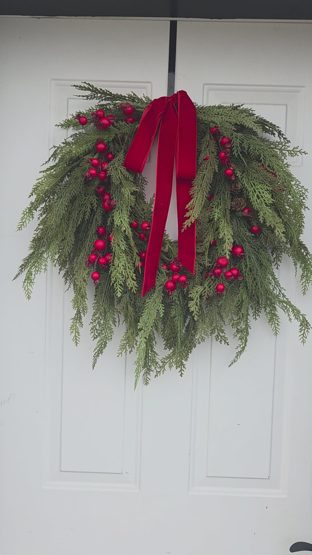 Outdoor faux Christmas wreath with red velvet bow – Lewiston MN home décor