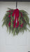 Outdoor faux Christmas wreath with red velvet bow – Lewiston MN home décor