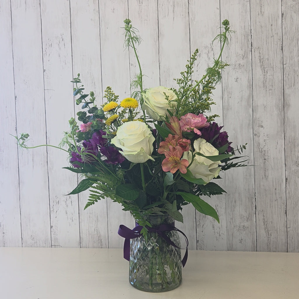 Video of a fresh seasonal flower arrangement in a vase being displayed at Heartland Store MN with mixed blooms and eucalyptus