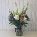 Video of a fresh seasonal flower arrangement in a vase being displayed at Heartland Store MN with mixed blooms and eucalyptus