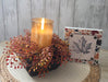 Artificial 8 inch rust orange berry candle ring displayed on white background showing detailed berries and natural texture