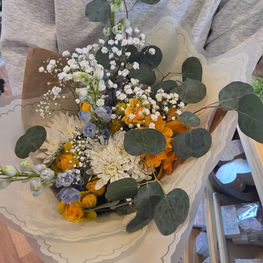 Fresh blue yellow and white pastel flower bundle hand tied spring bouquet