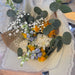 Spring fresh flowers arranged in pastel blue yellow and white tones close up