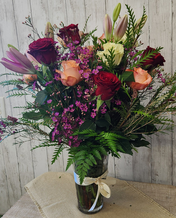 Close-up of roses and lilies in a luxury crystal vase arrangement designed by a Minnesota florist