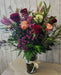 Close-up of roses and lilies in a luxury crystal vase arrangement designed by a Minnesota florist