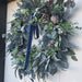 Outdoor front door wreath with blue berries and velvet bow – Lewiston MN home décor