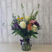 Fresh seasonal flower arrangement in vase with roses, carnations, and eucalyptus at Heartland Store MN