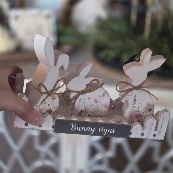 Easter block sitter bunnies displayed in wooden fence