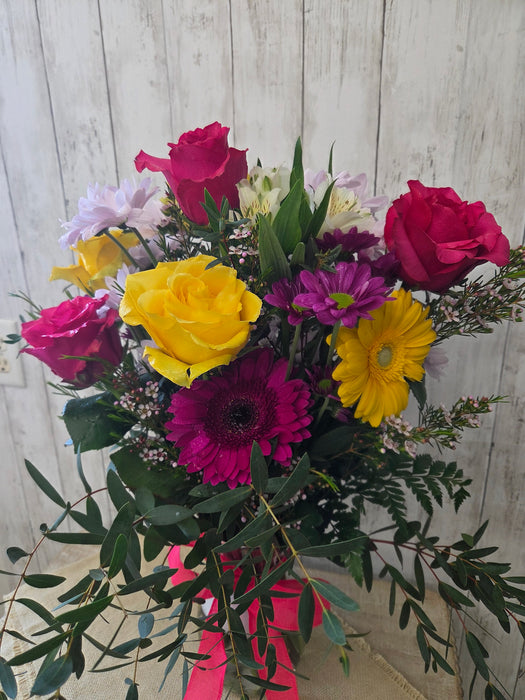 Gerbera daisies, roses, mums, and alstroemeria in a colorful fresh floral arrangement at a Minnesota gift shop