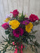 Gerbera daisies, roses, mums, and alstroemeria in a colorful fresh floral arrangement at a Minnesota gift shop