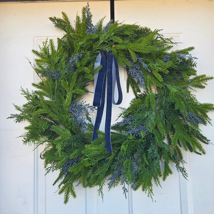 Elegant outdoor UV-treated Christmas wreath with blue berries and velvet ribbon – Winona MN decor