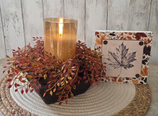 Detailed texture shot of artificial berries and foliage on fall candle ring showing maintenance-free quality
