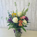 Colorful fresh flower bouquet featuring purples, pinks, whites, yellow, orange, and greenery from Heartland Store Minnesota