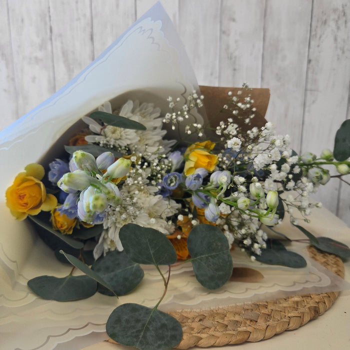 Pastel fresh flower bundle with daisies and seasonal blooms in soft spring colors