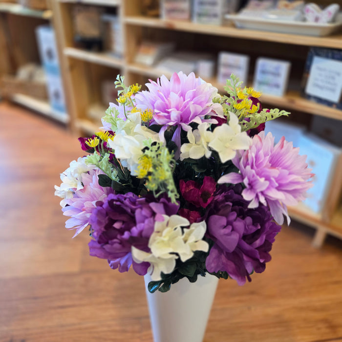 Purple silk cemetery flowers with yellow colorful accents