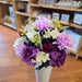 Purple silk cemetery flowers with yellow colorful accents