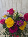 Fresh flower arrangement in vase with yellow, purple, and lavender blooms and eucalyptus from Heartland Store MN