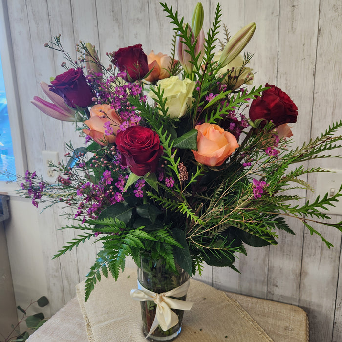 Elegant crystal vase floral arrangement with red, pink, salmon, and purple flowers from a Minnesota flower shop