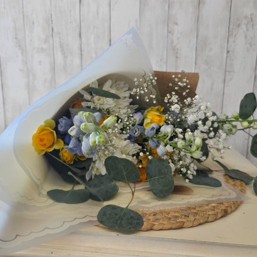 Hand tied fresh pastel flowers in blue yellow and white for spring home decor or Mother's Day Flowers